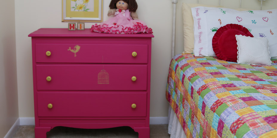 The made-over dresser and hardware pick up colors from the bed cover
