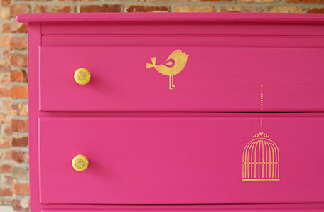 The yellow stencils perfectly match the drawer pulls