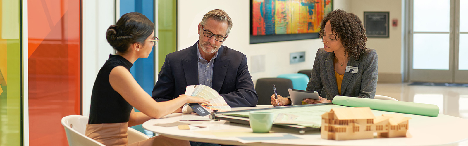 Large image of 2 Pro painters painting the wooden railings of the exterior of an apartment block.