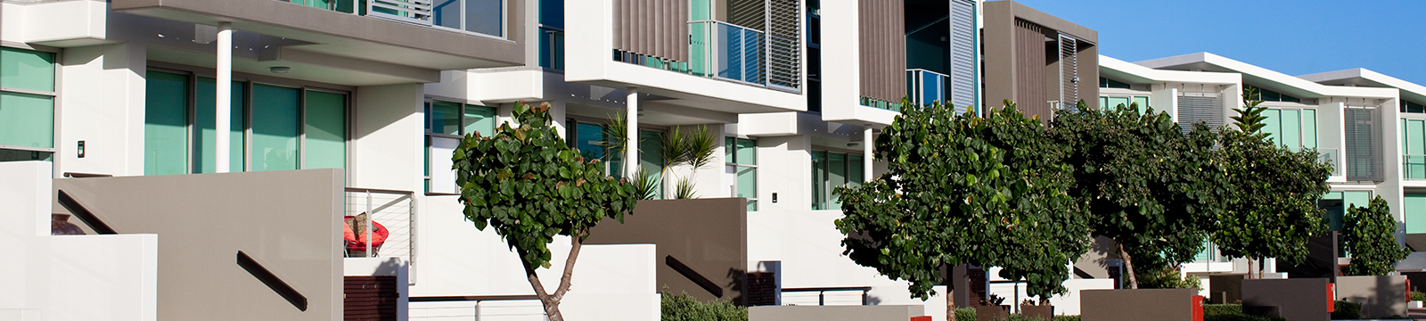 Large image of an exterior of a multi-family home properties next to each other.