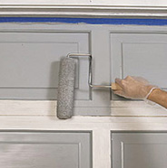 Roll paint onto garage facings.