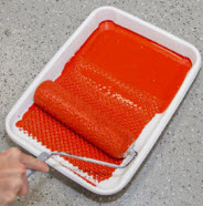 Roll roller in paint tray.