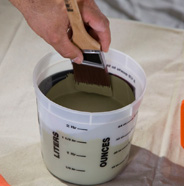 Dip brush into paint pail.
