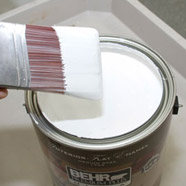 Paint brush dipped into paint.