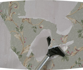 Scrapping tool removing wallpaper from a wall