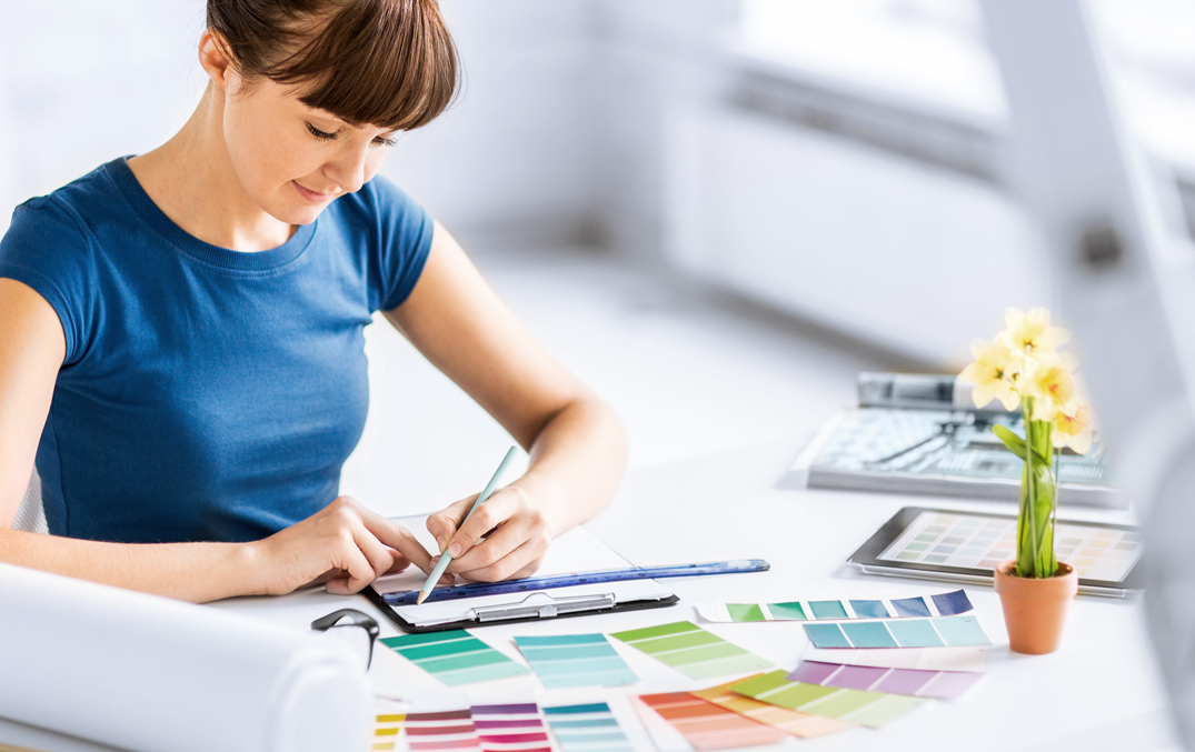 A woman looking at several different color palettes