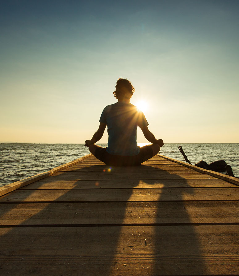 A person relaxing at the end of a dock mobile.