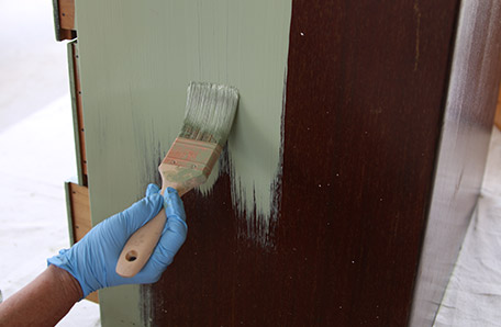 first coat of paint being applied to sewing desk