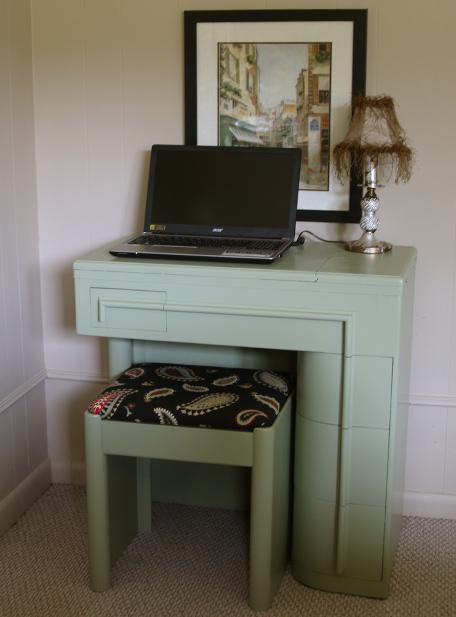 finished desk with laptop and furnishings