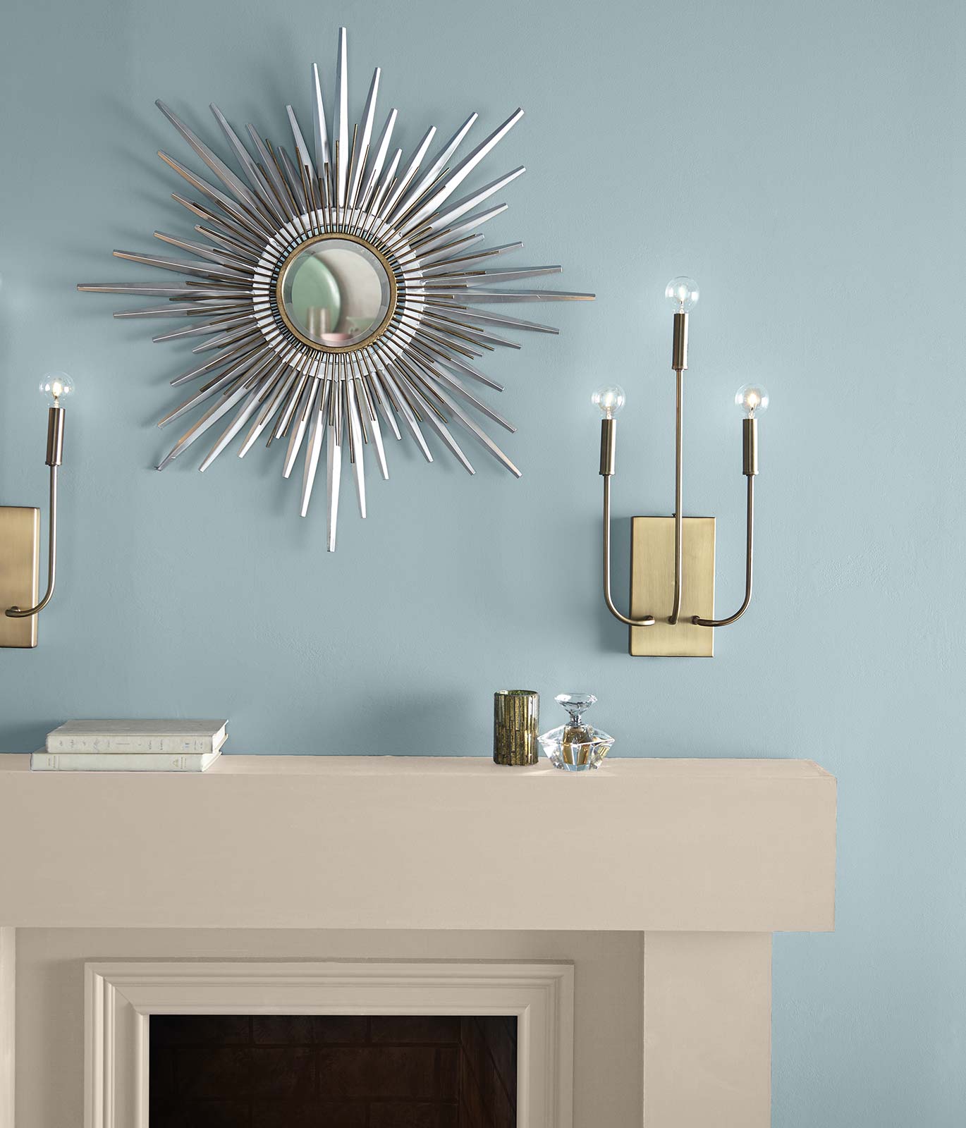 A tight crop of a cream colored fireplace against a denim blue painted wall inspiring a calm feeling